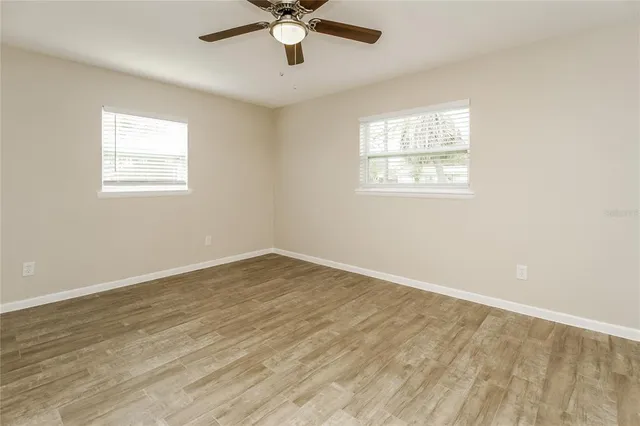 wooden floor in an empty room with a window