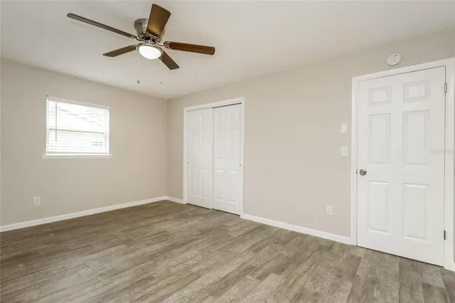 wooden floor in an empty room with a window
