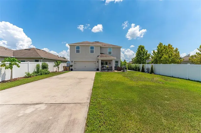 a view of a house with a yard and a fountain