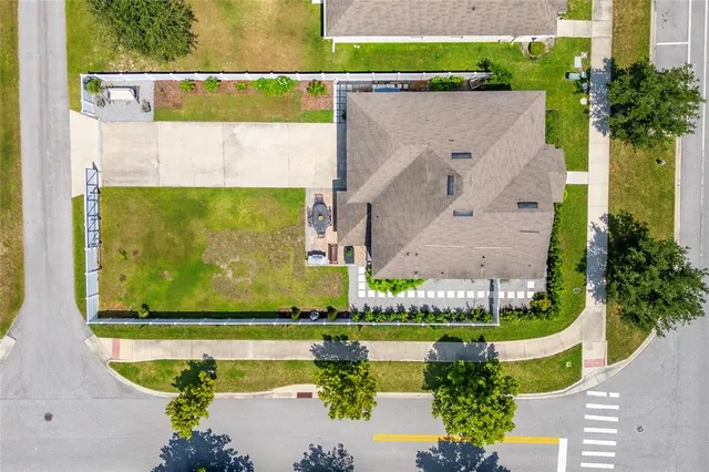 an aerial view of residential houses with outdoor space and swimming pool