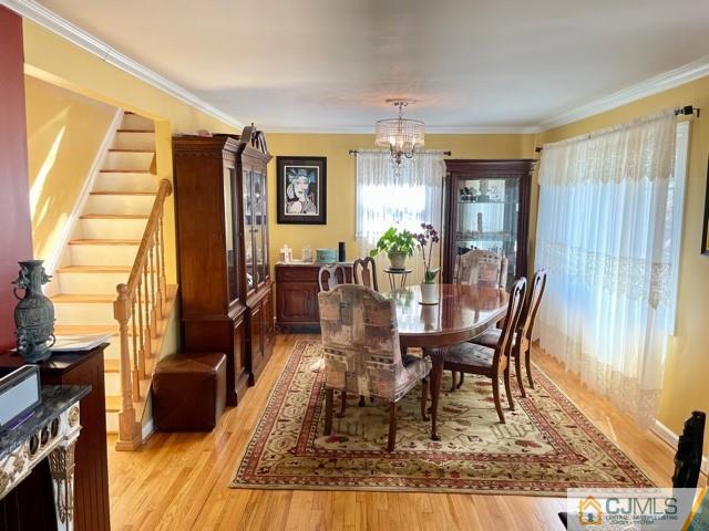 5 Bowser Road New Brunswick, NJ 08901 - Photo 13 of 45 a dining room with furniture a chandelier and wooden floor