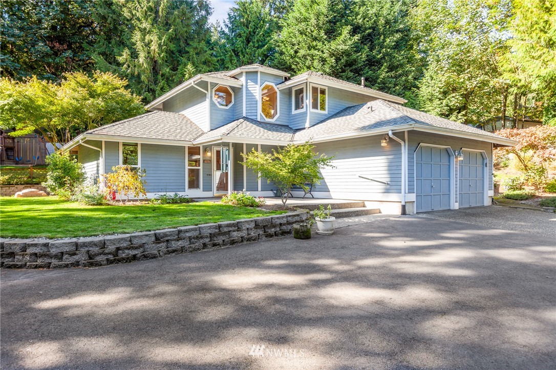 21814 4th Avenue Southeast Bothell, WA 98021 - Photo 1 of 25 a front view of a house with a yard and garage