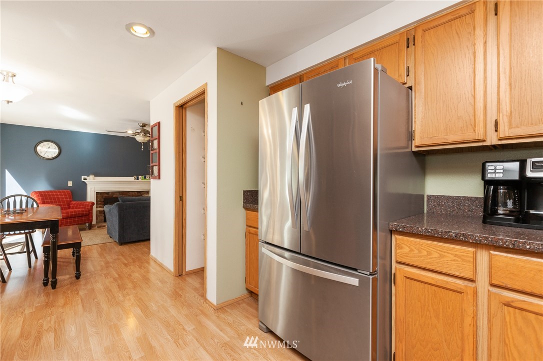21814 4th Avenue Southeast Bothell, WA 98021 - Photo 11 of 25 a kitchen with stainless steel appliances granite countertop a refrigerator a stove and a sink with cabinets