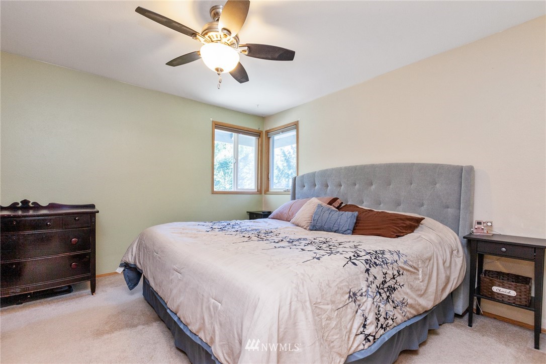 21814 4th Avenue Southeast Bothell, WA 98021 - Photo 14 of 25 a bedroom with a bed and a chandelier