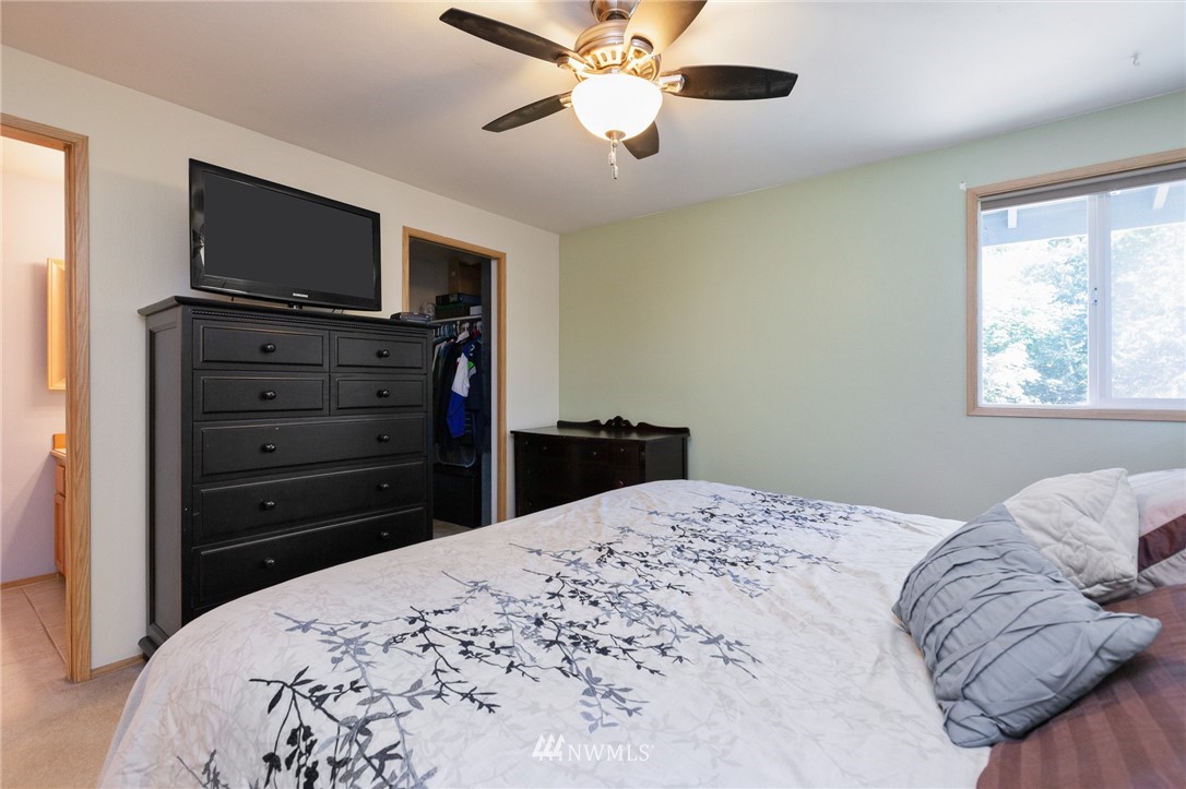 21814 4th Avenue Southeast Bothell, WA 98021 - Photo 15 of 25 a bedroom with a bed and a flat tv screen on dresser