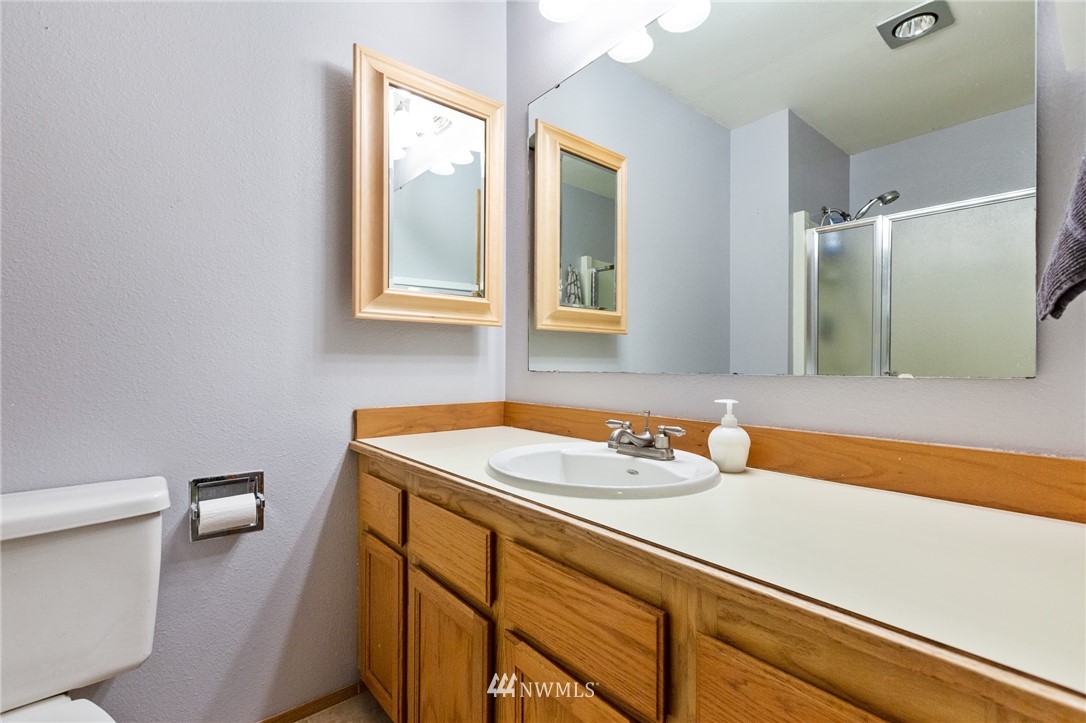 21814 4th Avenue Southeast Bothell, WA 98021 - Photo 16 of 25 a bathroom with a sink and a mirror