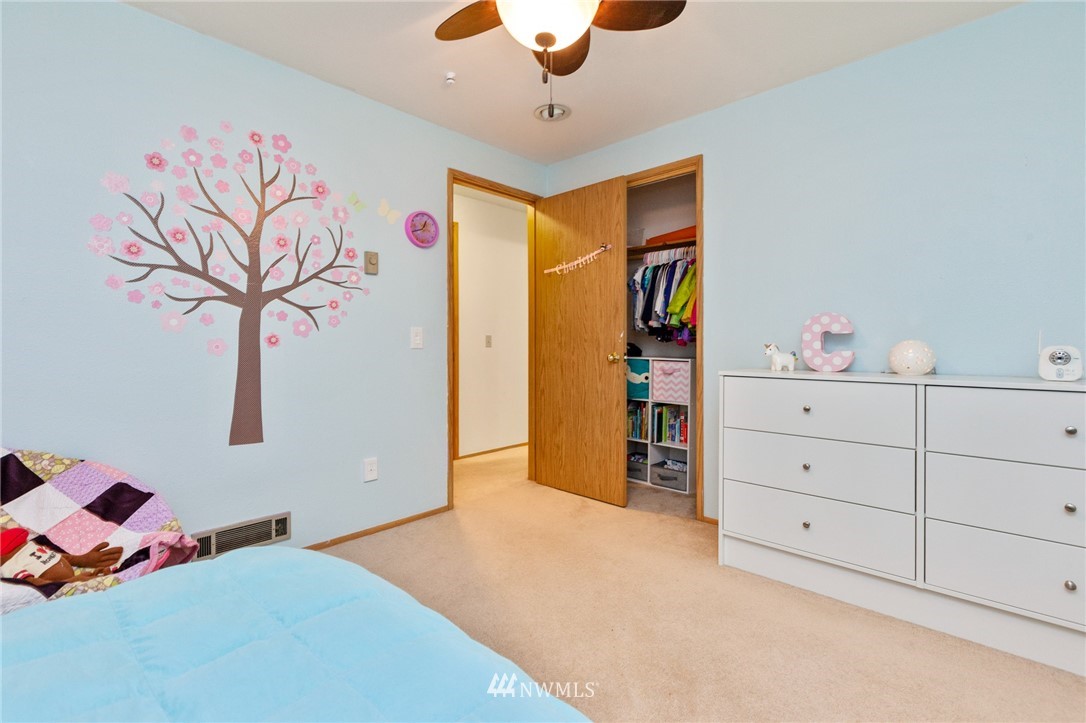 21814 4th Avenue Southeast Bothell, WA 98021 - Photo 18 of 25 a bedroom with a bed and a chandelier