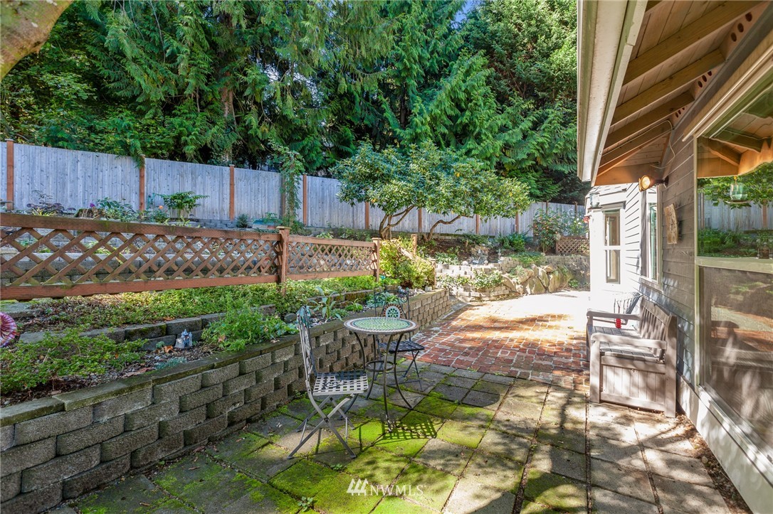 21814 4th Avenue Southeast Bothell, WA 98021 - Photo 24 of 25 a view of backyard with table and chairs and wooden fence