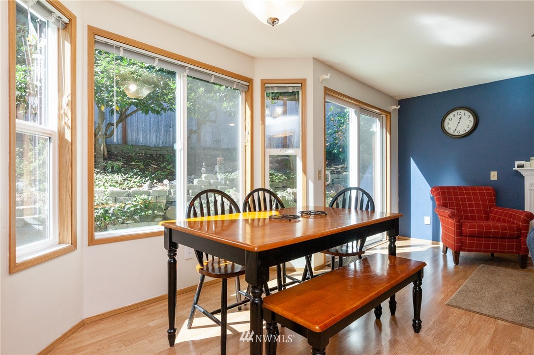 21814 4th Avenue Southeast Bothell, WA 98021 - Photo 8 of 25 a dining room with furniture a rug and a large window