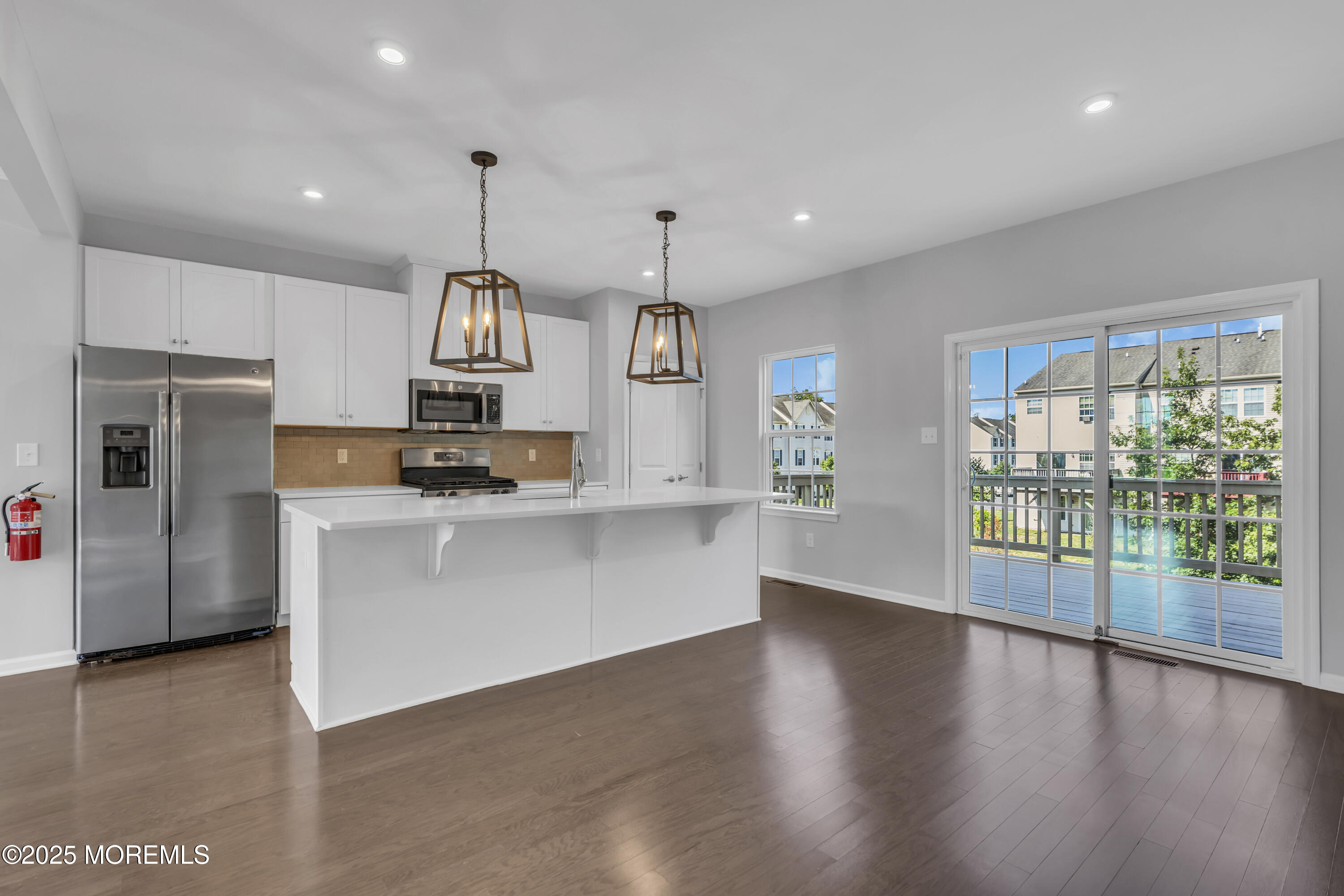 201 Rio Grande Drive Toms River, NJ 08755 - Photo 15 of 32 a kitchen with stainless steel appliances granite countertop a refrigerator a stove top oven a sink and a large window