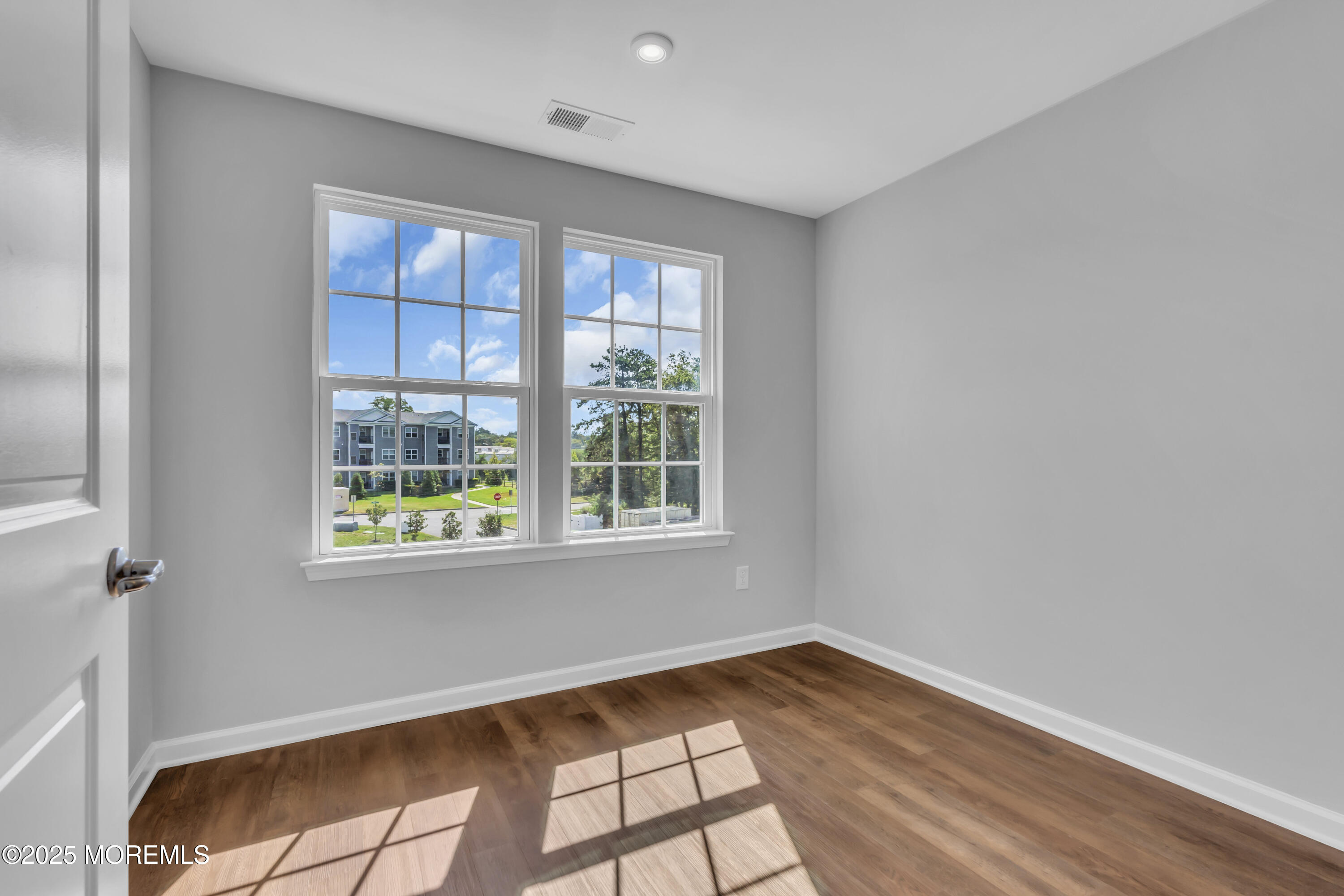 201 Rio Grande Drive Toms River, NJ 08755 - Photo 28 of 32 a view of an empty room with wooden floor and a window