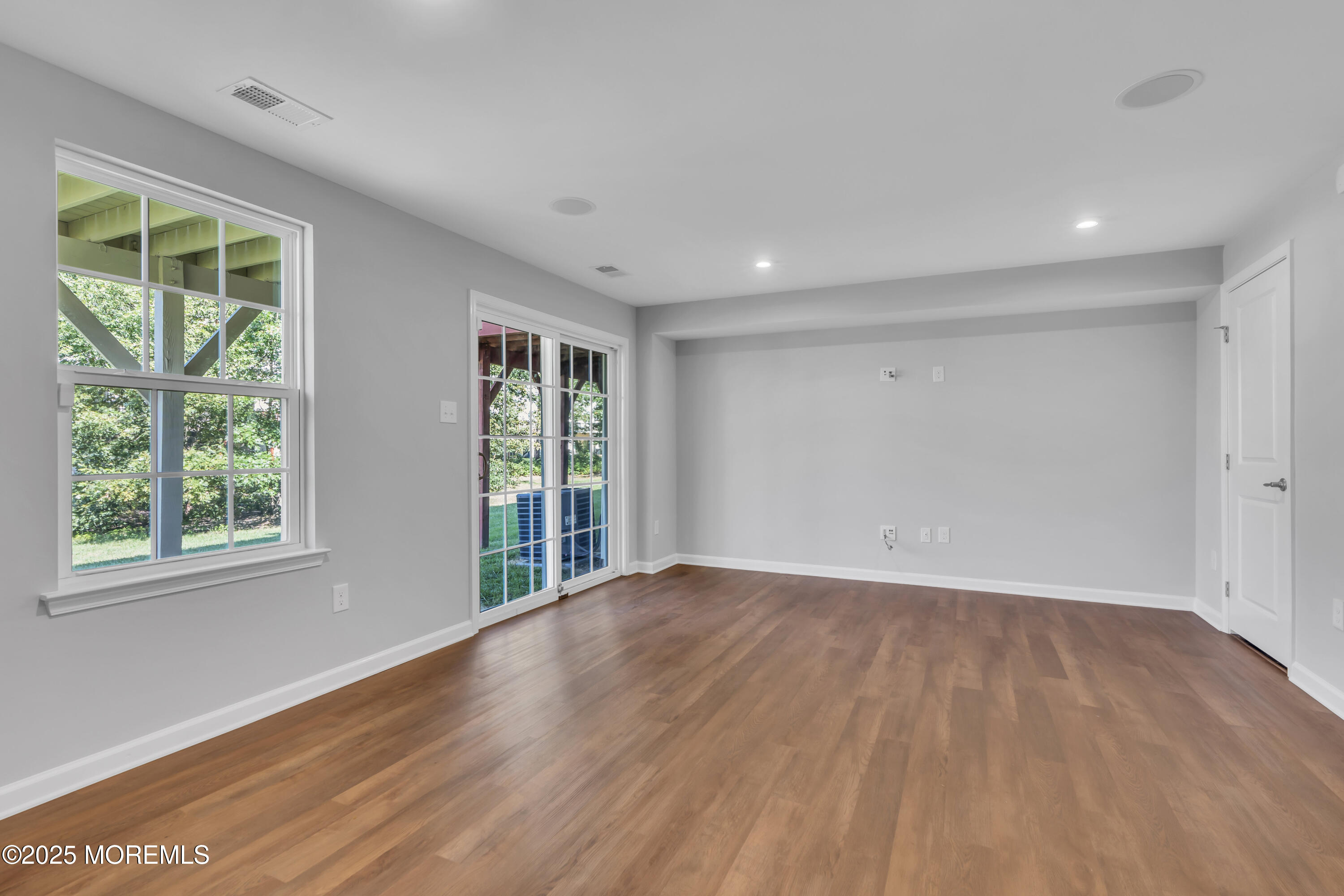 201 Rio Grande Drive Toms River, NJ 08755 - Photo 5 of 32 a view of an empty room with wooden floor and a window