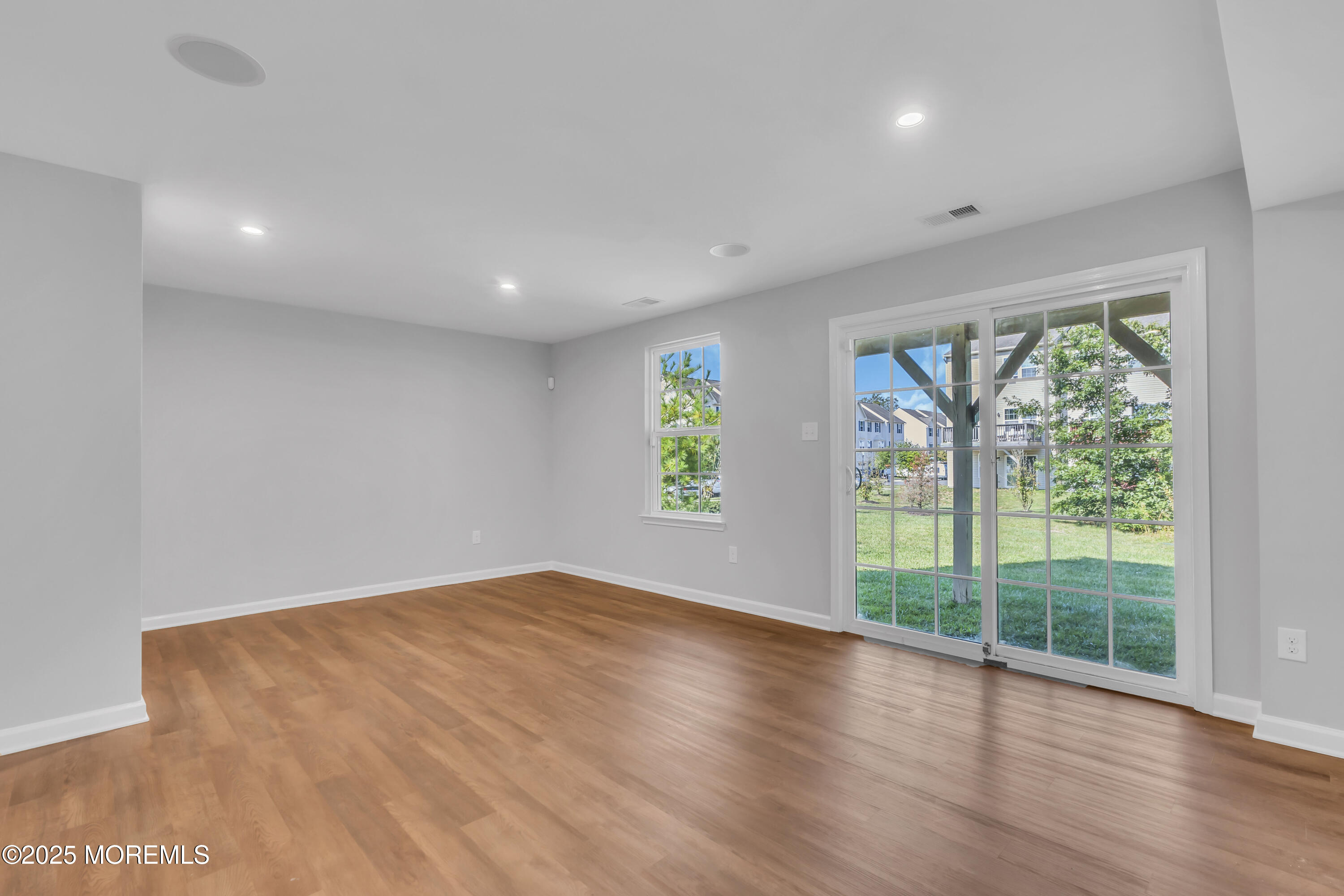 201 Rio Grande Drive Toms River, NJ 08755 - Photo 7 of 32 a view of empty room with wooden floor and fan