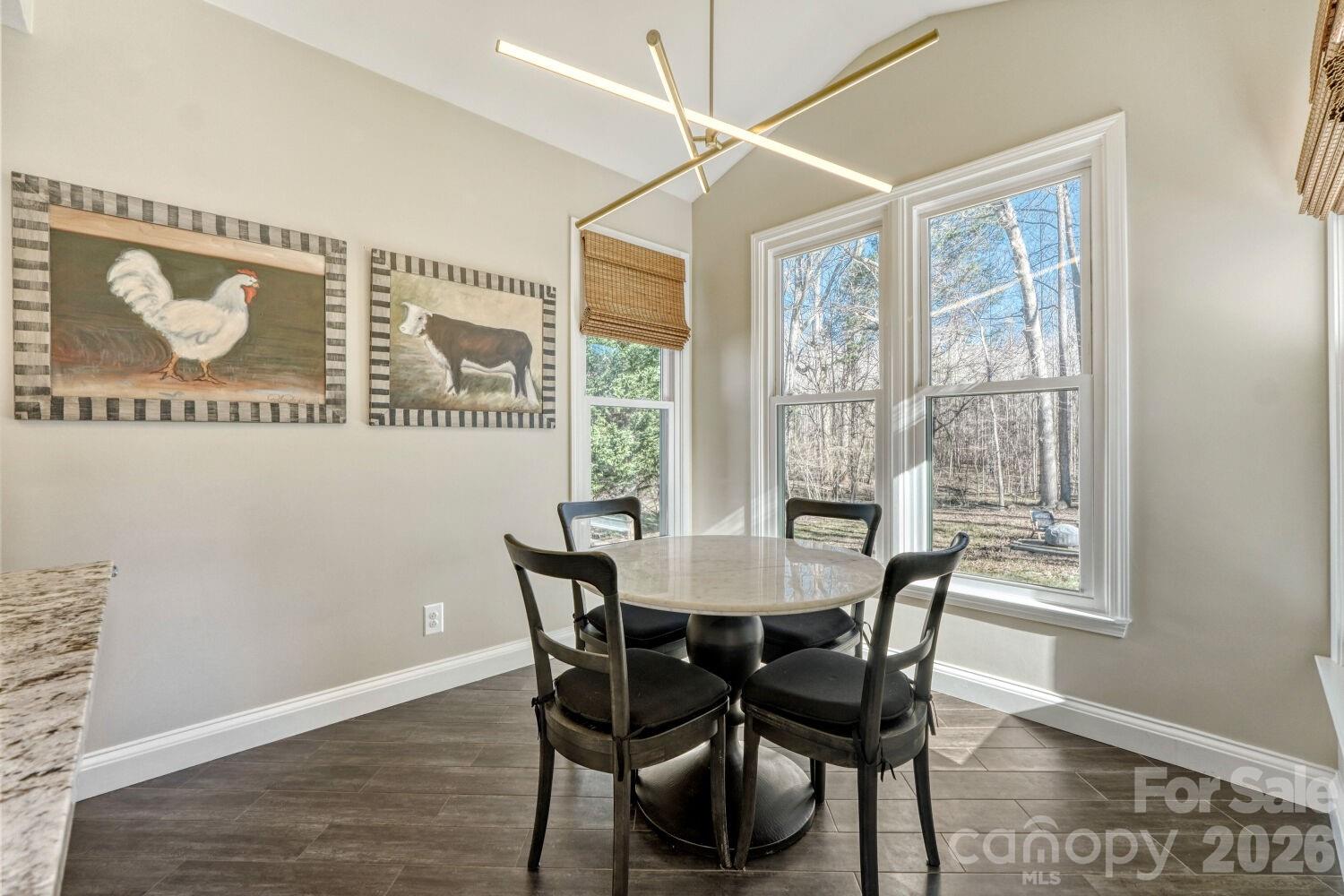8607 Forest Shadow Circle Cornelius, NC 28031 - Photo 11 of 45 a view of a dining room with furniture and wooden floor