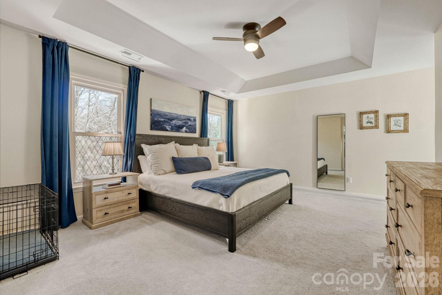8607 Forest Shadow Circle Cornelius, NC 28031 - Photo 17 of 45 a spacious bedroom with a bed and a large window