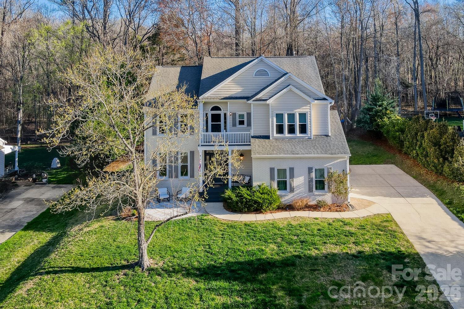 8607 Forest Shadow Circle Cornelius, NC 28031 - Photo 2 of 45 a front view of a house with garden