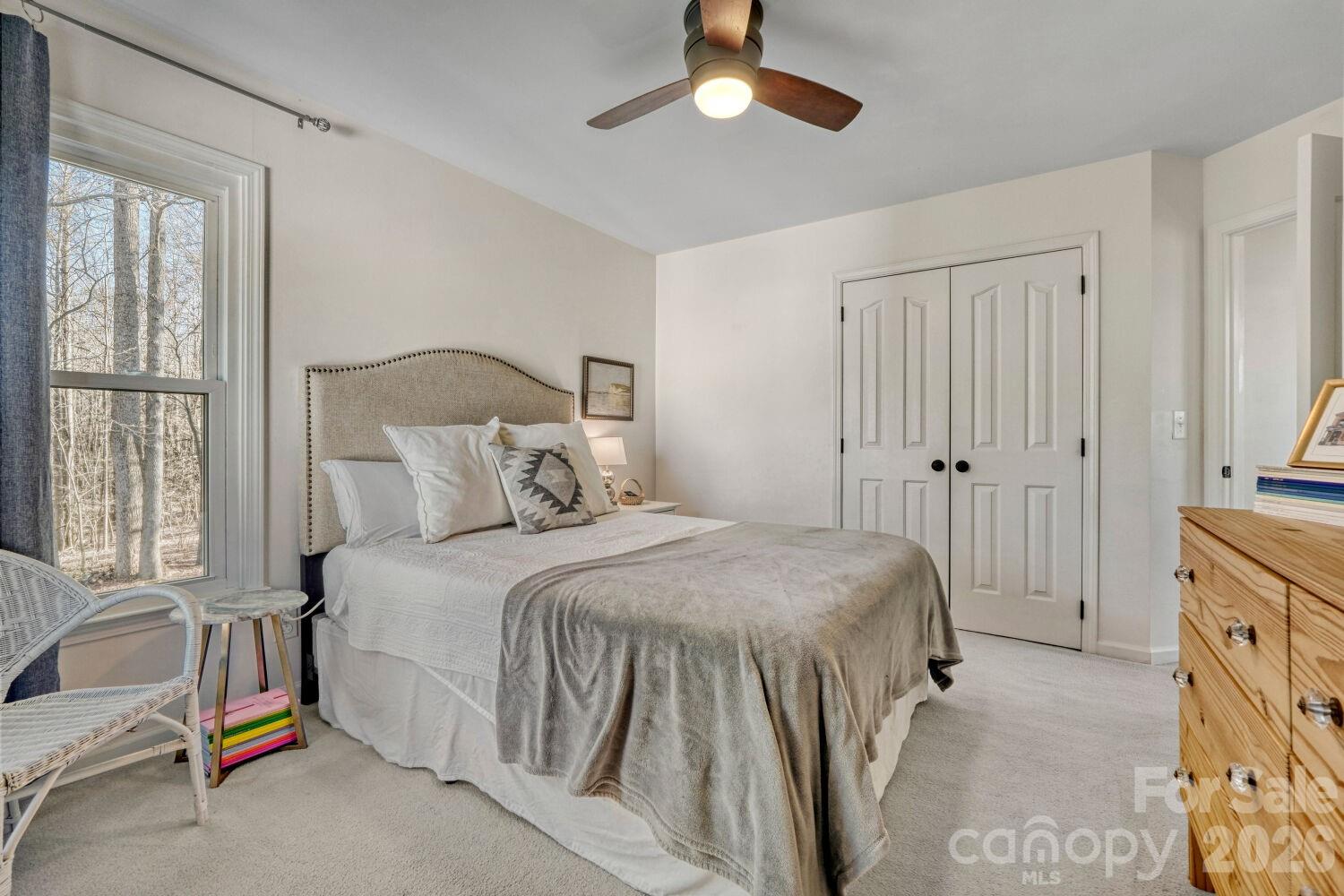 8607 Forest Shadow Circle Cornelius, NC 28031 - Photo 21 of 45 a spacious bedroom with a bed and a window