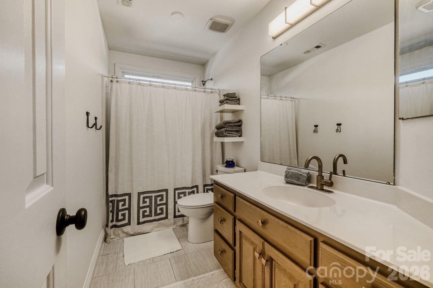 8607 Forest Shadow Circle Cornelius, NC 28031 - Photo 23 of 45 a bathroom with a sink double vanity and a mirror