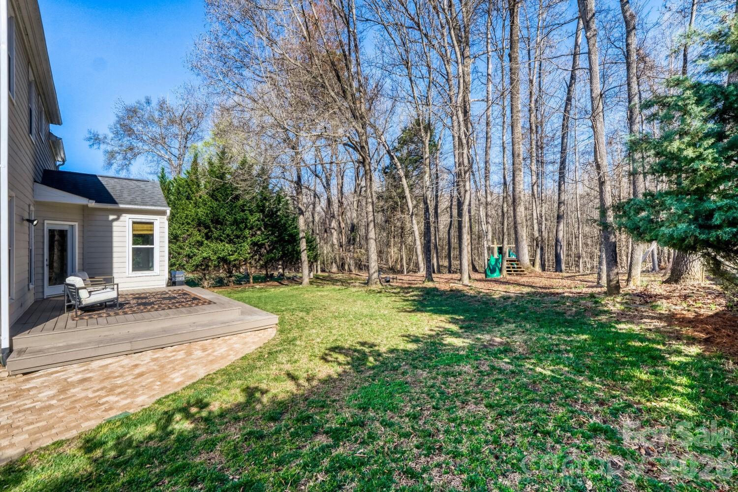 8607 Forest Shadow Circle Cornelius, NC 28031 - Photo 26 of 45 a backyard of a house with table and chairs