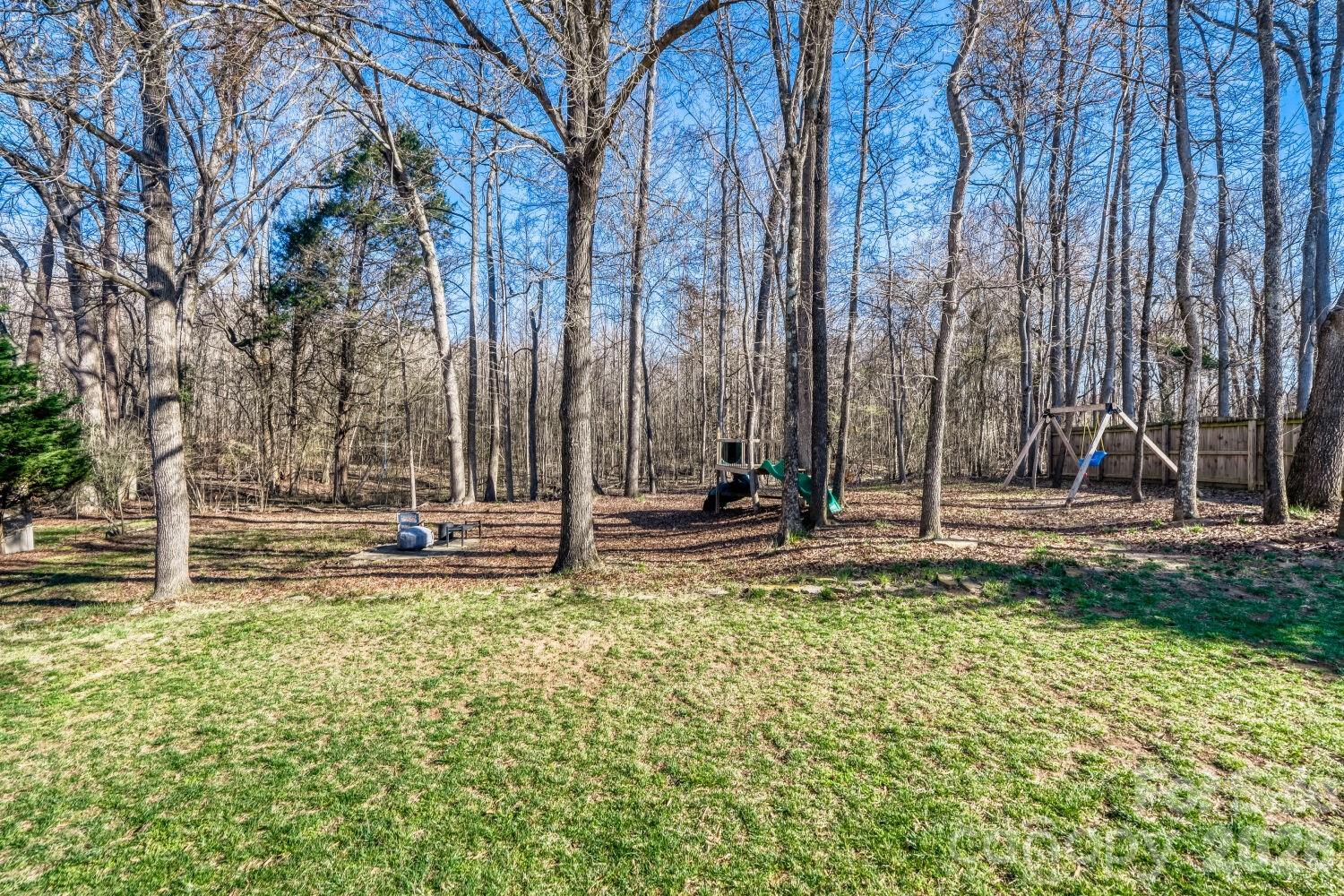 8607 Forest Shadow Circle Cornelius, NC 28031 - Photo 29 of 45 a view of a swimming pool with a bench and trees