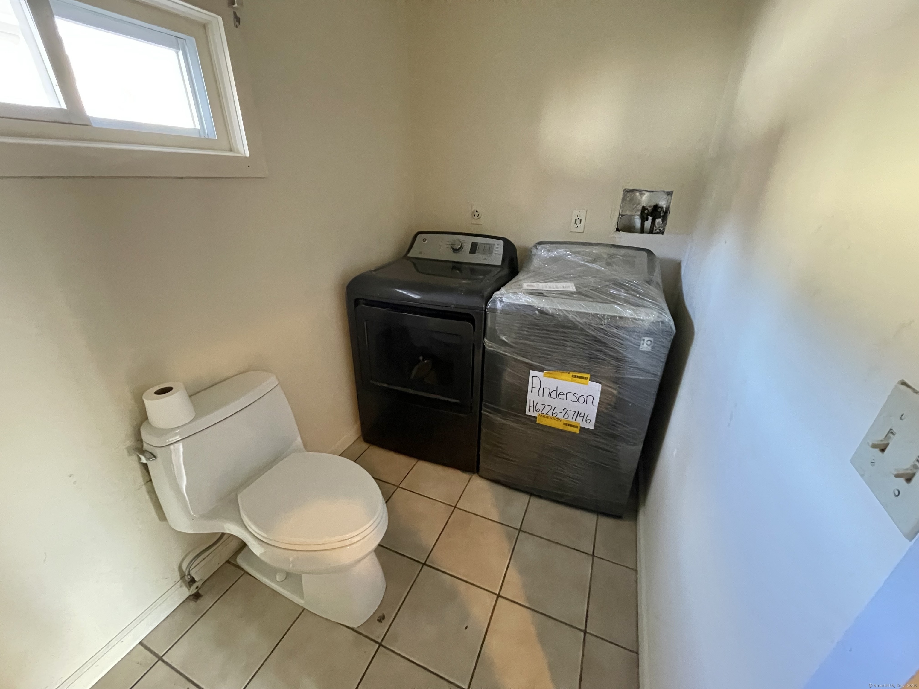 25 Pleasant Street Ansonia, CT 06401 - Photo 21 of 25 a bathroom with a toilet and a sink