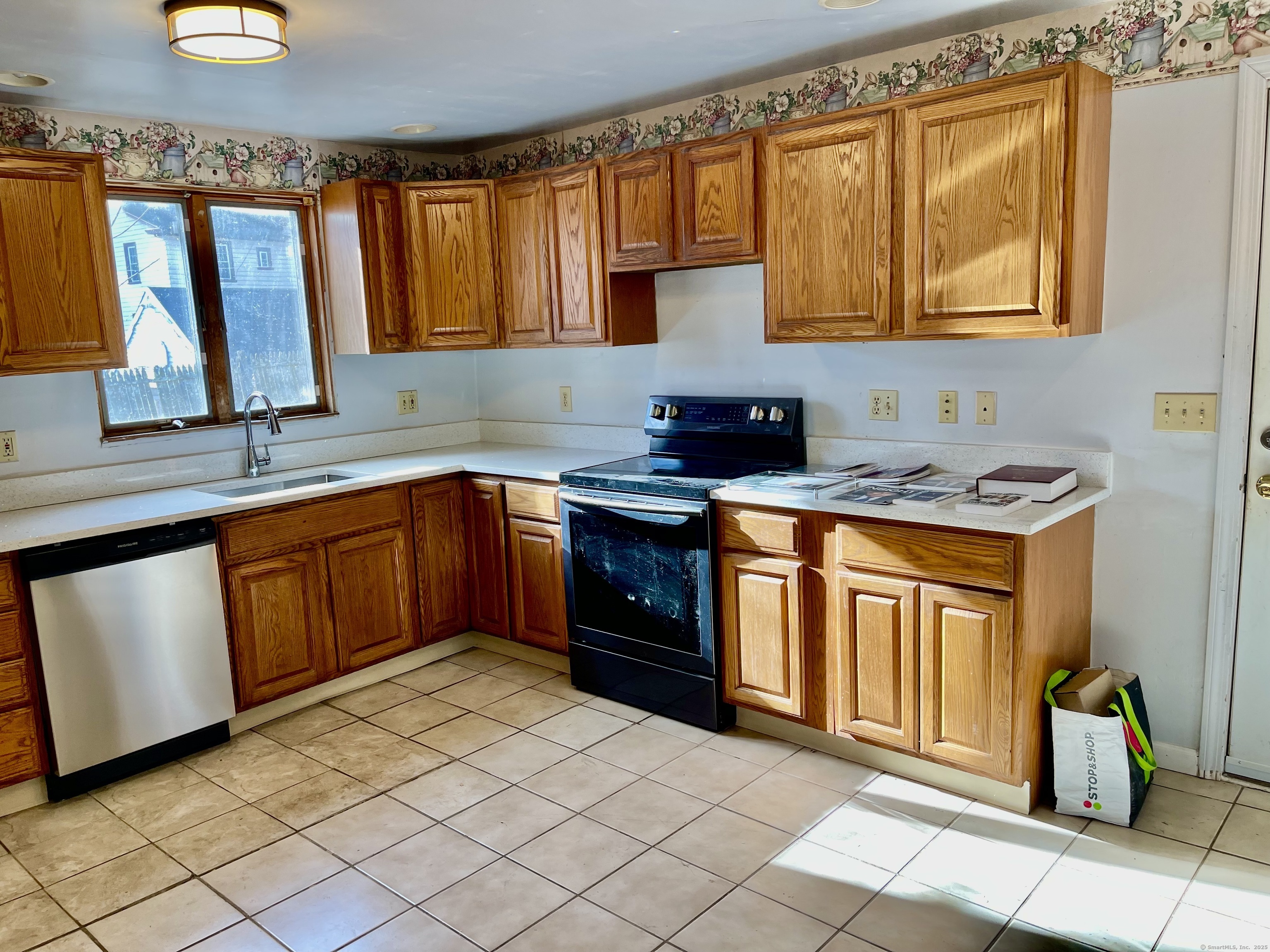 25 Pleasant Street Ansonia, CT 06401 - Photo 4 of 25 a kitchen with stainless steel appliances granite countertop a stove sink and cabinets