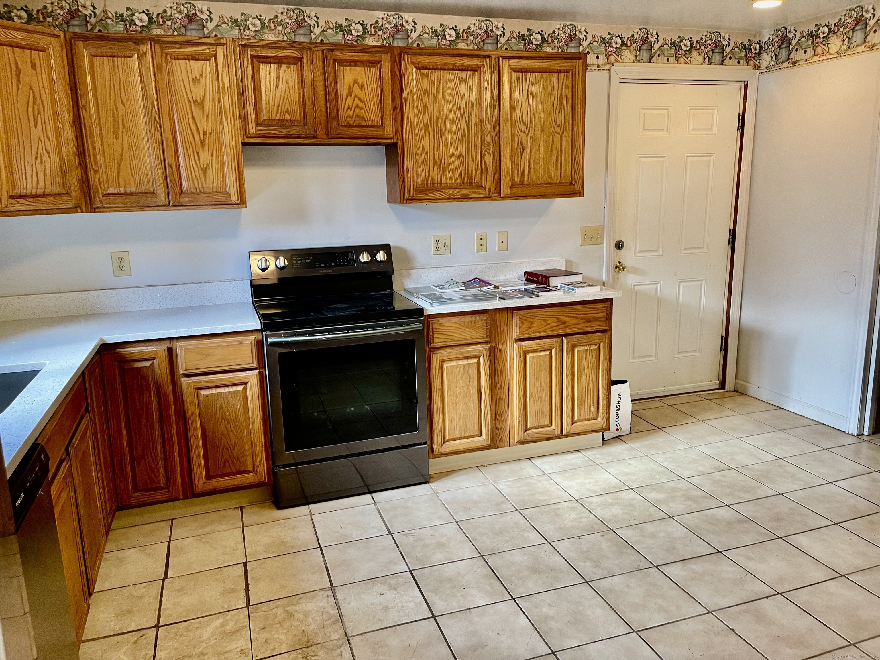 25 Pleasant Street Ansonia, CT 06401 - Photo 5 of 25 a kitchen with granite countertop a stove a sink and a refrigerator