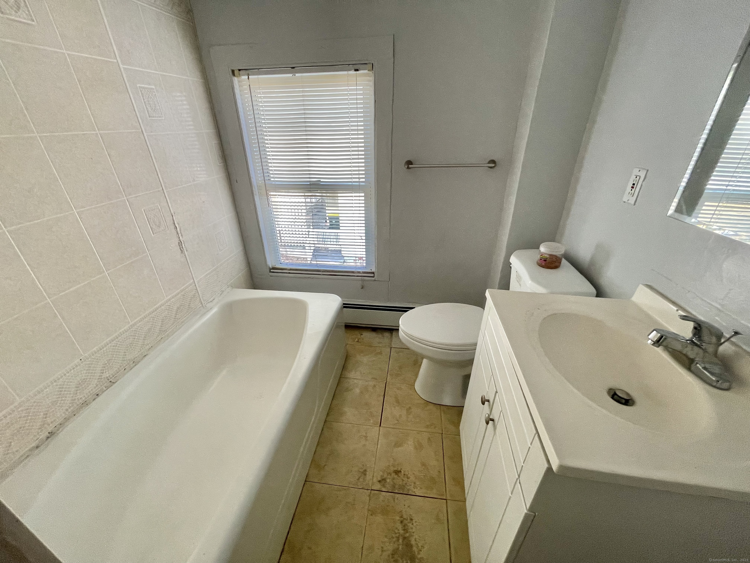 25 Pleasant Street Ansonia, CT 06401 - Photo 8 of 25 a bathroom with a sink a toilet and bathtub
