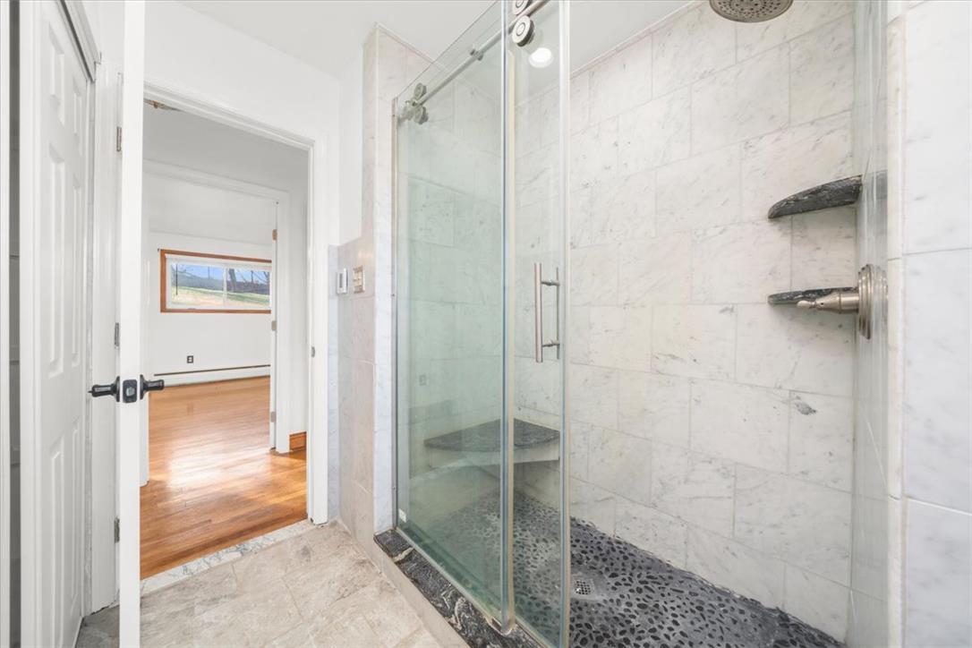 988 Hoch Road Danielsville, PA 18038 - Photo 7 of 29 A spacious, naturally illuminated shower with elegant tile work and stone accents.
