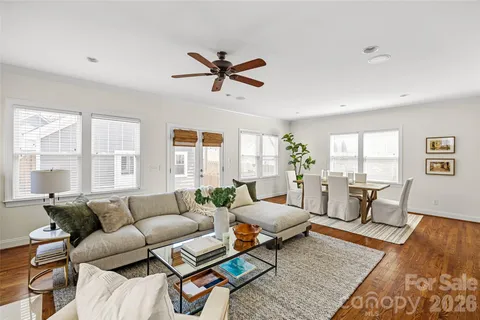 a living room with furniture and wooden floor