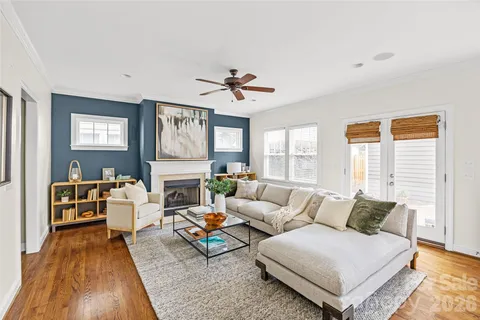 a living room with furniture fireplace and a window