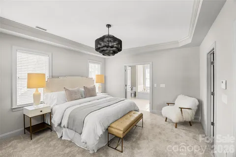 a bedroom with a bed and a chandelier