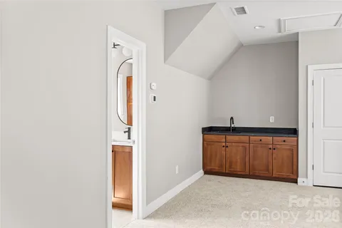 a bathroom with a sink toilet and a mirror