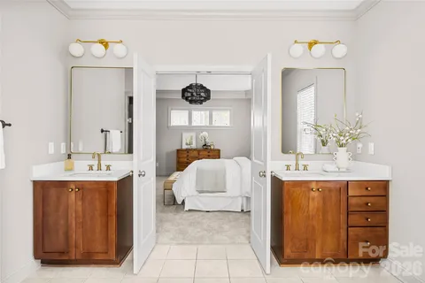 a en suite bathroom with a double vanity sink and a mirror