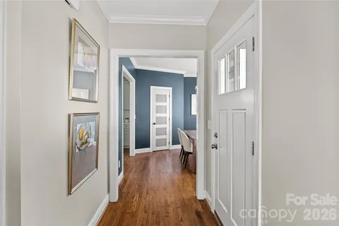a view of a hallway with wooden floor and entryway
