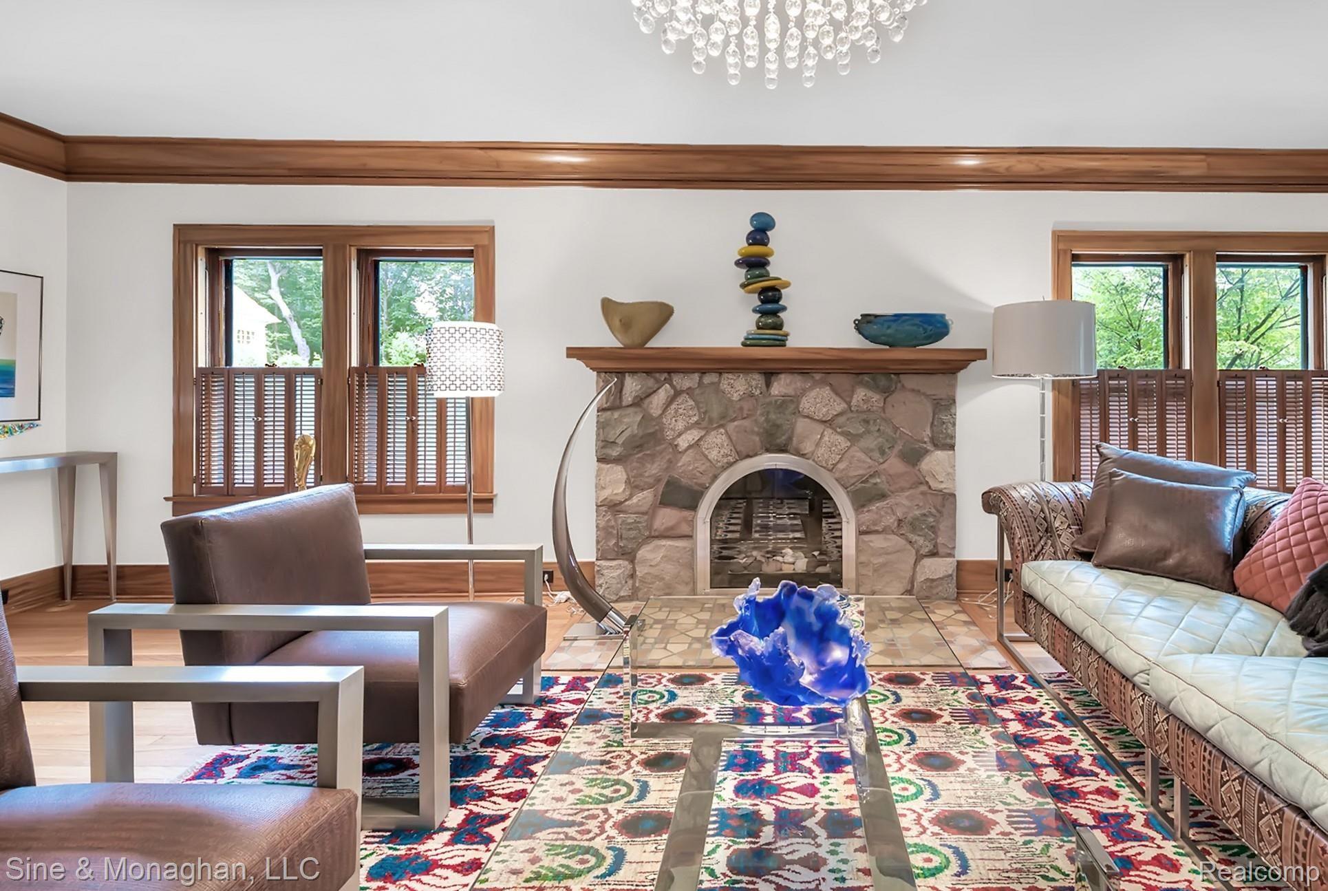 1158 West Maple Road Birmingham, MI 48009 - Photo 10 of 77 Living room with stone gas fireplace, wood floors, wonderful crown moulding
