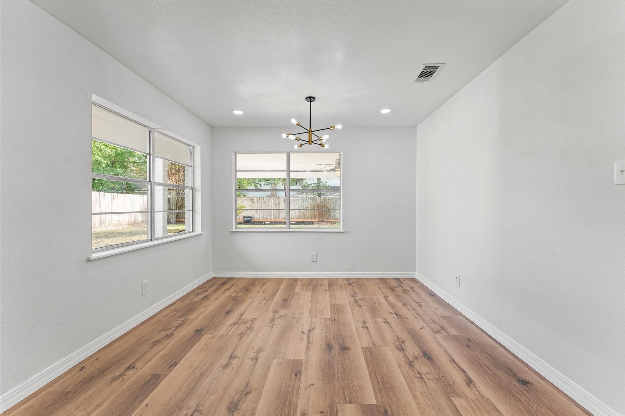 1123 Suwanee Lane Houston, TX 77090 - Photo 12 of 39 wooden floor in an empty room with a window