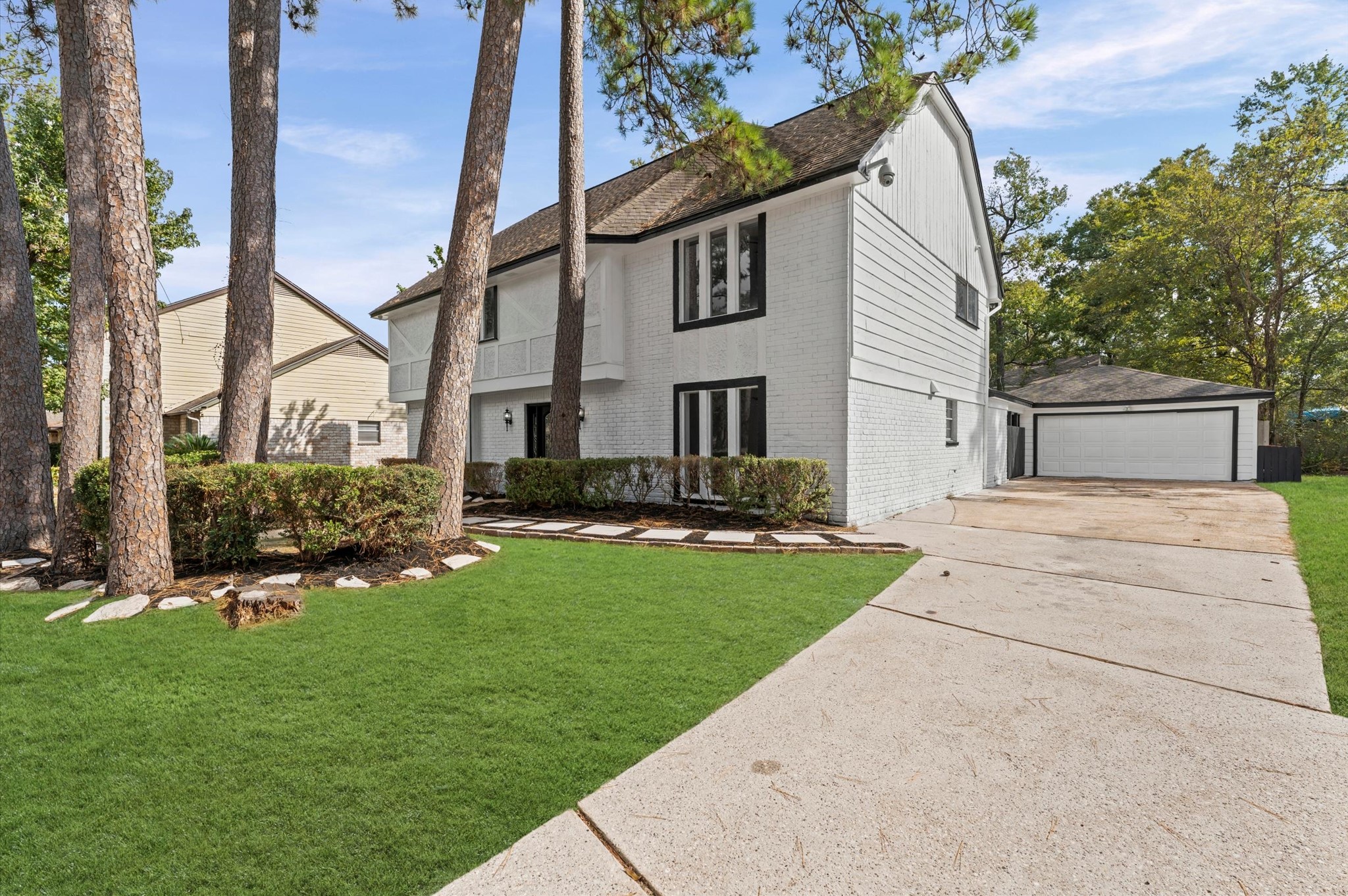 1123 Suwanee Lane Houston, TX 77090 - Photo 32 of 39 a front view of a house with a yard and trees