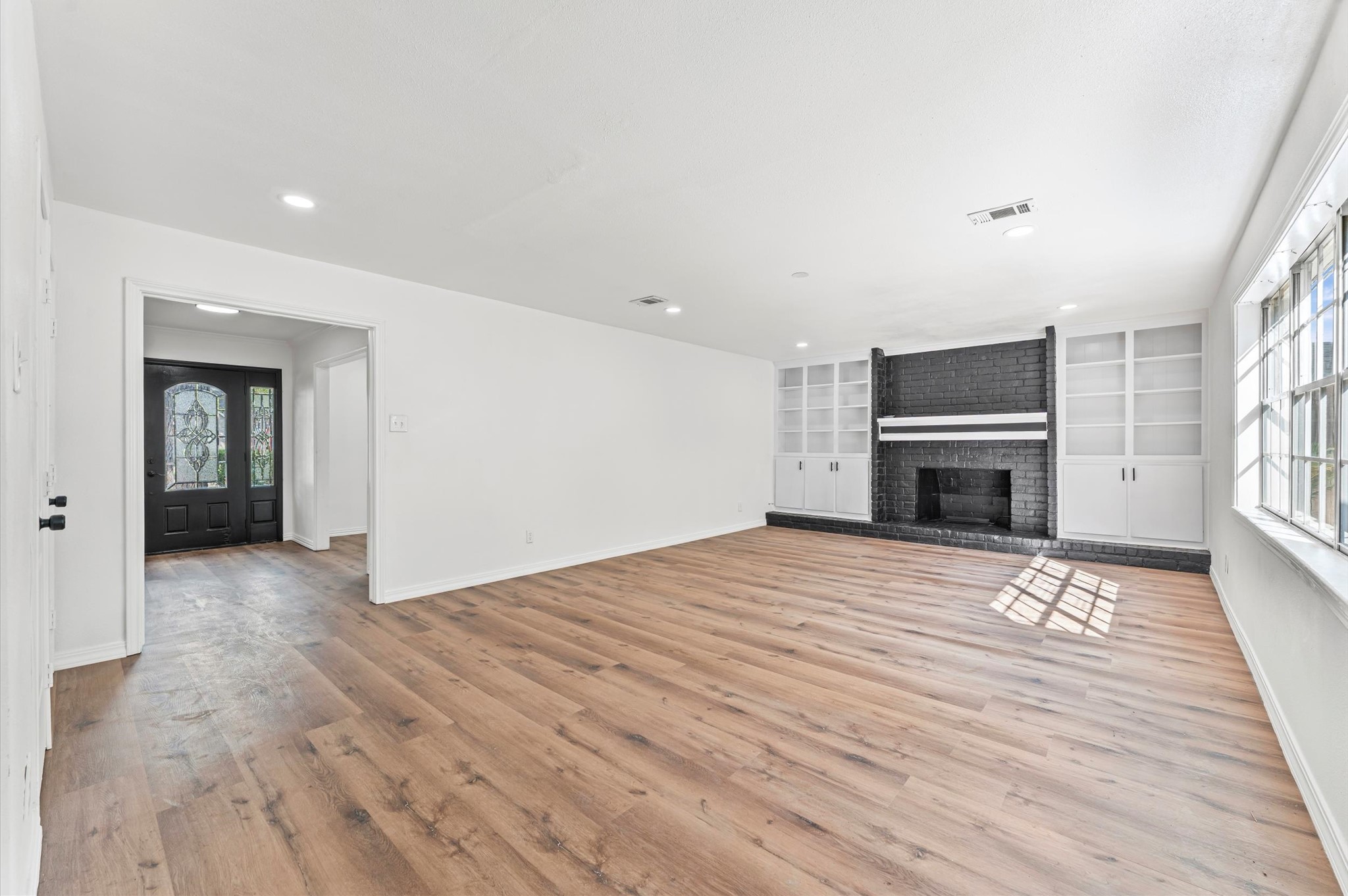 1123 Suwanee Lane Houston, TX 77090 - Photo 9 of 39 a view of empty room with wooden floor and fireplace