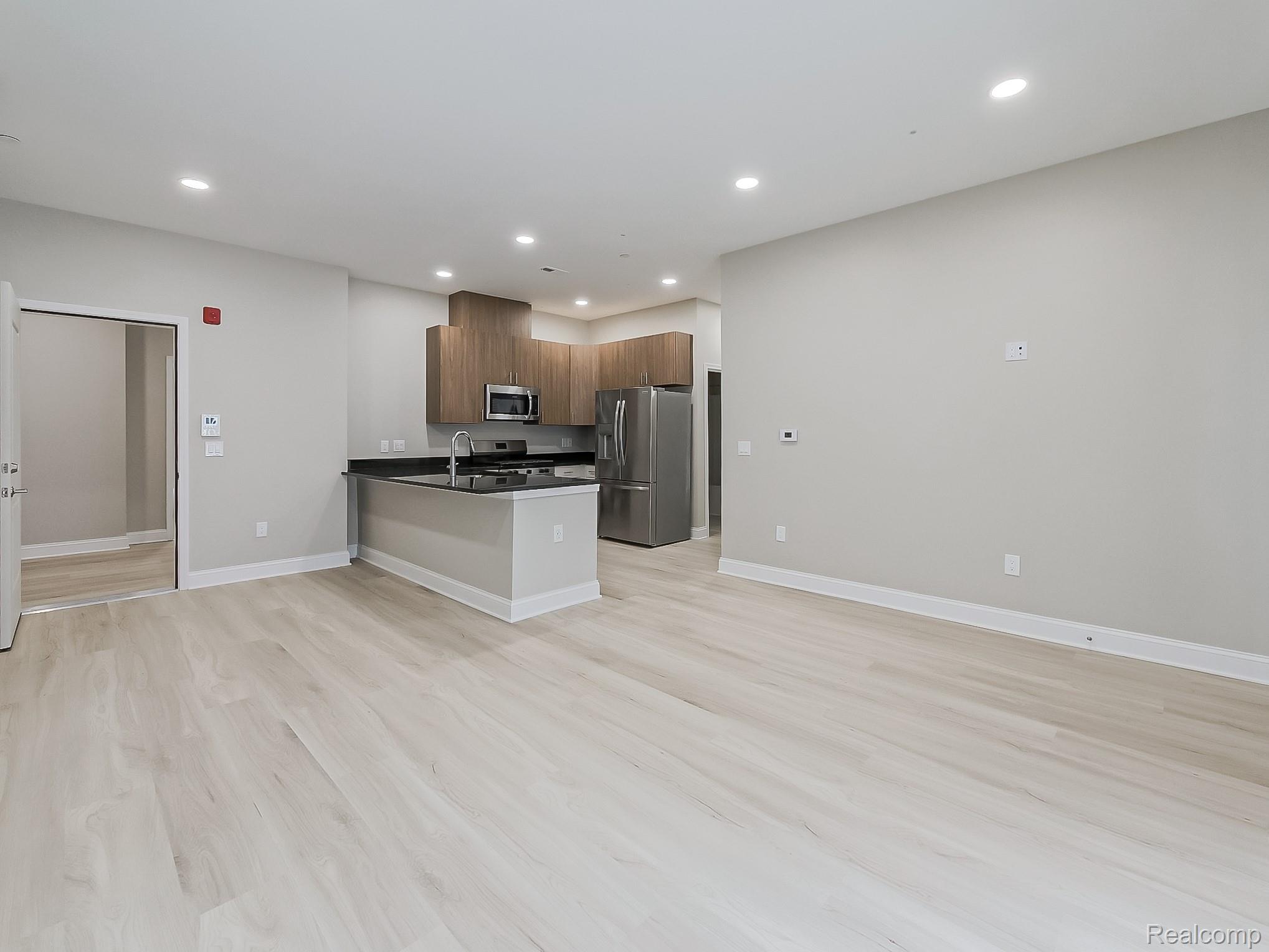 31480 Warren Road, Unit 101 Westland, MI 48185 - Photo 24 of 26 Kitchen featuring open floor plan, stainless steel appliances, modern cabinets, recessed lighting, and a peninsula