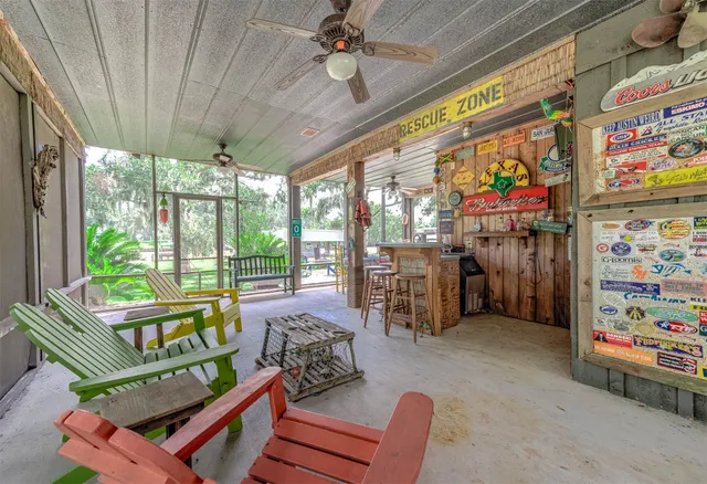 a living room with patio furniture and a floor to ceiling window