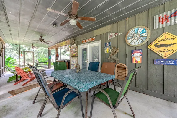 a dining room with furniture a rug and a clock