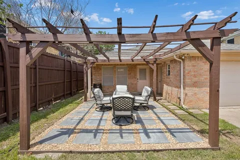 a view of a patio with a table and chairs