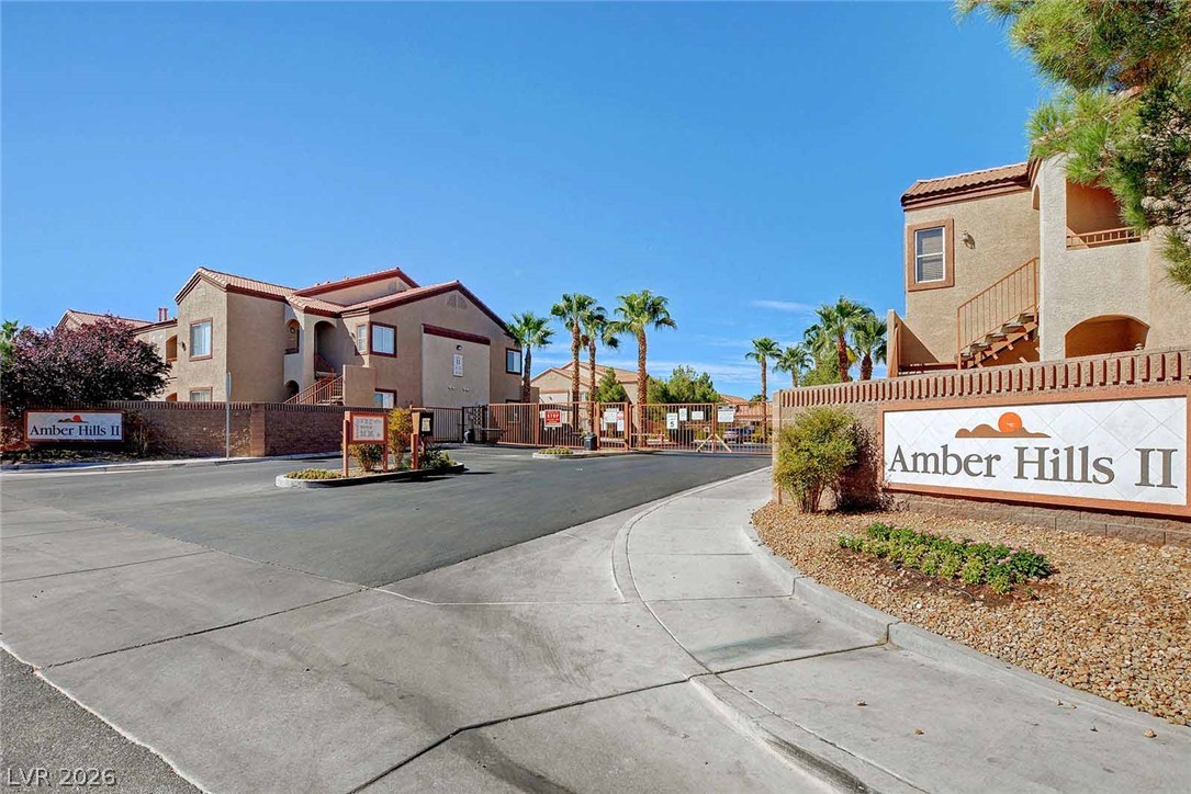 9580 West Reno Avenue, Unit 134 Las Vegas, NV 89148 - Photo 33 of 41 Secure community entrance with palm trees welcomes residents to this well-maintained development.