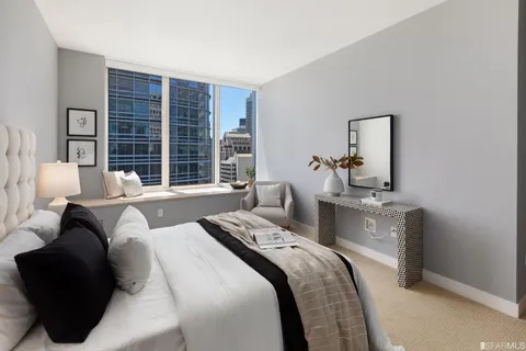 a bedroom with a bed and a lamp