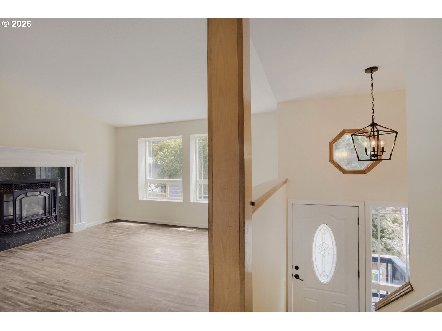 14539 Southeast Center Street Portland, OR 97236 - Photo 4 of 30 a view of an empty room with a fireplace and wooden floor