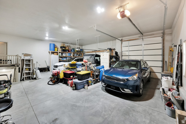 302 Old Farm Road Tooele, UT 84074 - Photo 20 of 30 Spacious garage featuring concrete flooring and two overhead garage doors
