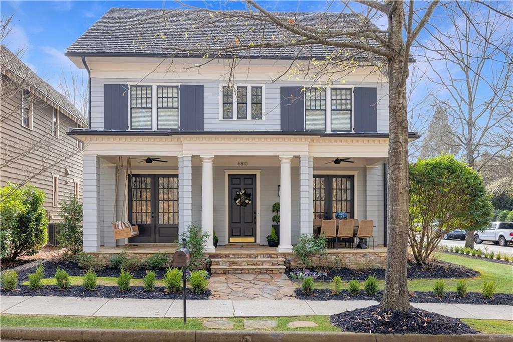 6810 Lullwater Road Cumming, GA 30040 - Photo 1 of 63 a front view of a house with garden
