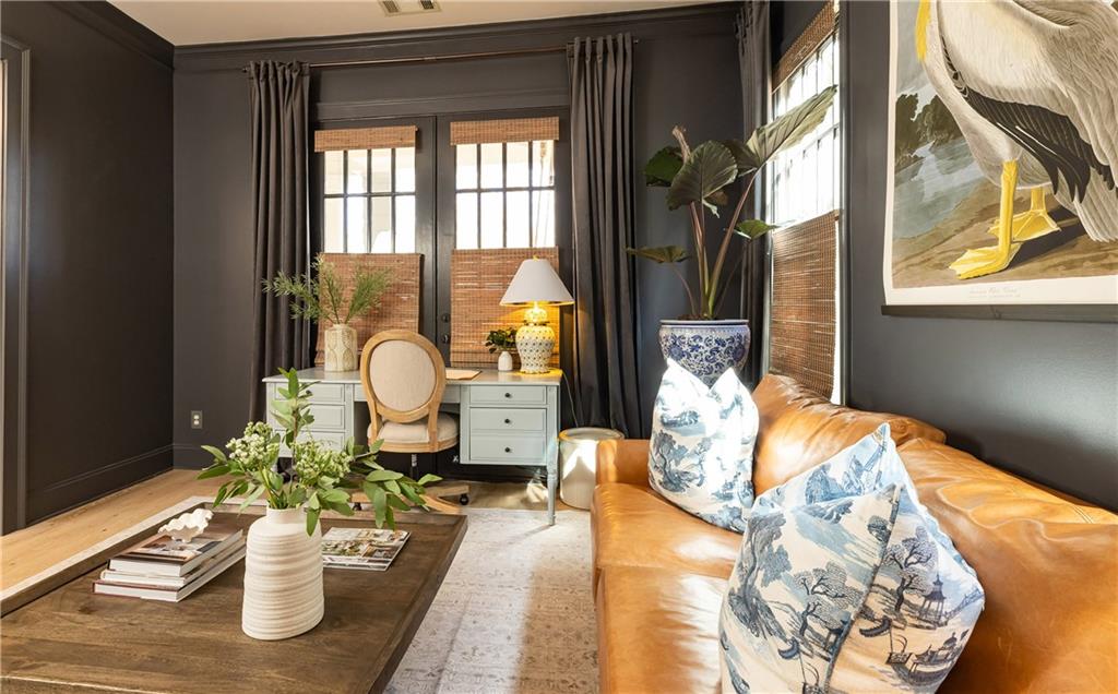 6810 Lullwater Road Cumming, GA 30040 - Photo 11 of 63 a vase of flowers sitting on a table with a potted plant