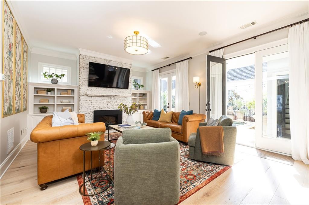 6810 Lullwater Road Cumming, GA 30040 - Photo 12 of 63 a living room with furniture a flat screen tv and a fireplace